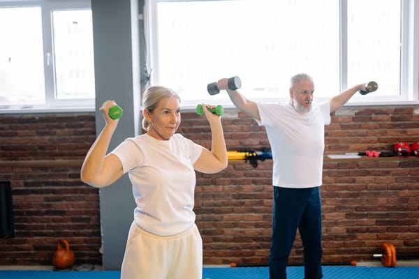 Residents engaged in a fitness class with weights