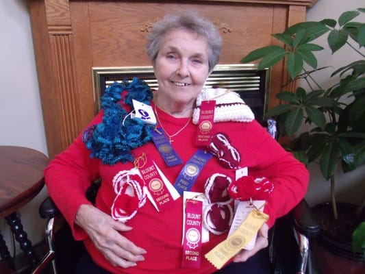 Resident displaying award ribbons in a common area