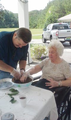 Staff member assisting resident with gardening activity