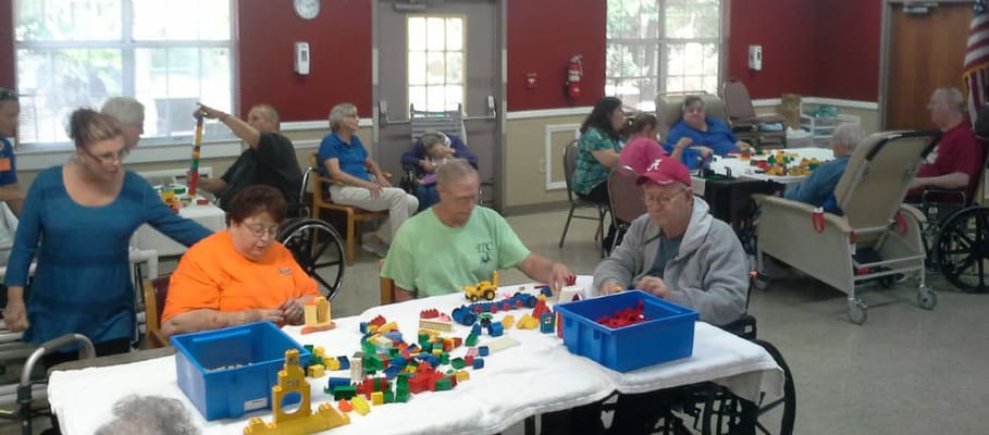 Residents engaging in a group activity with colorful toys