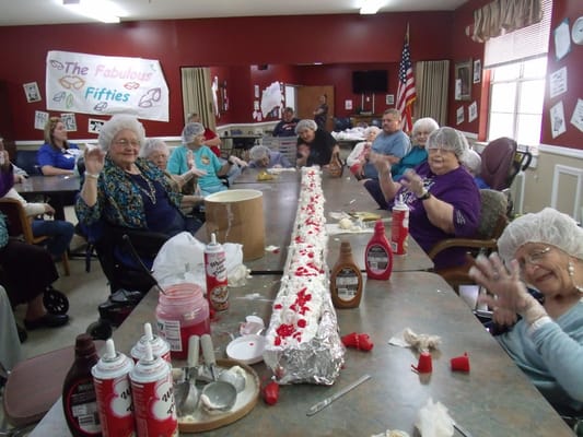 Residents celebrating in a common area with decorations
