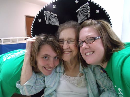 Residents and staff posing together with smiles