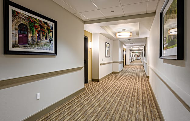 Interior hallway featuring art and warm lighting