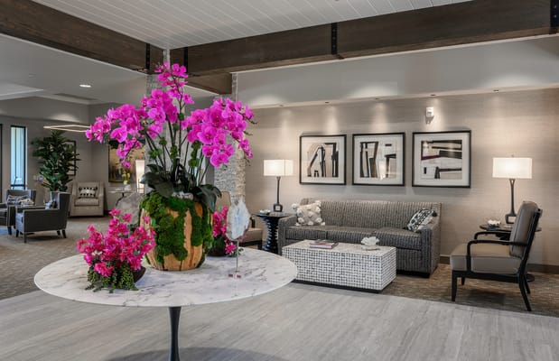 Bright lobby area with decorative flowers and seating