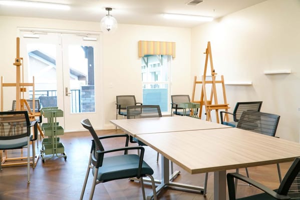 Interior activity room with art easels and tables