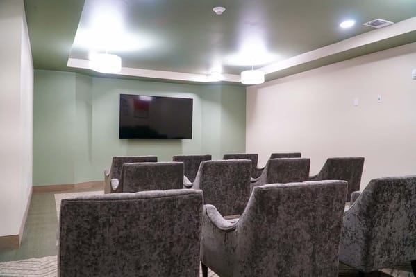 Common area with chairs and a television