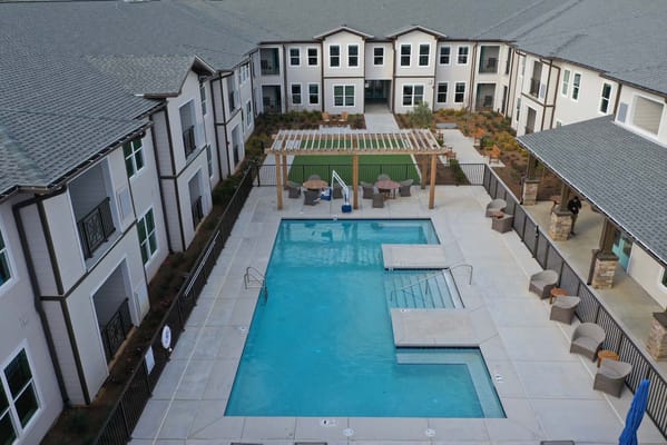 Aerial view of a pool area surrounded by residential buildings