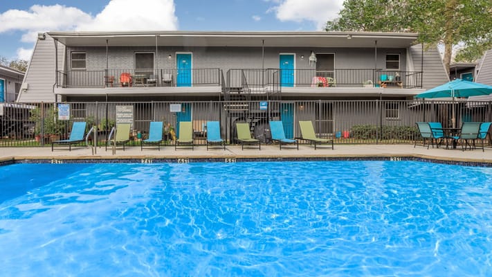 Building exterior with a pool and seating area