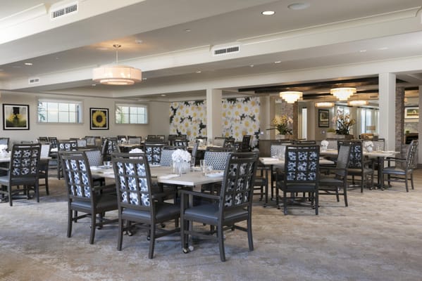 Bright dining room with tables and chairs set up for meals