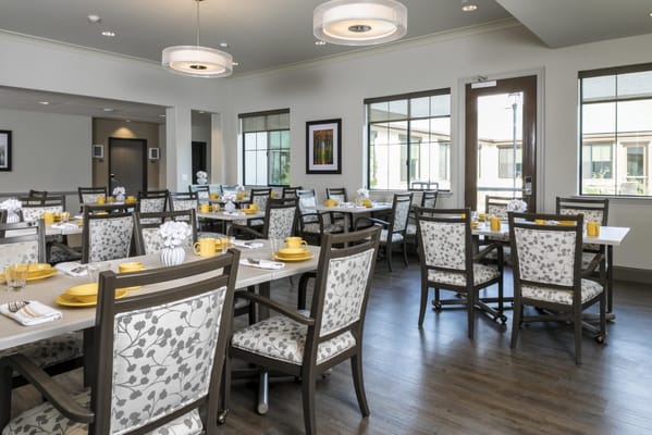 Bright dining room with tables set for a meal