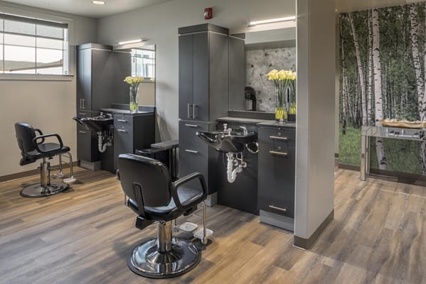 Beauty salon area with styling chairs and decor