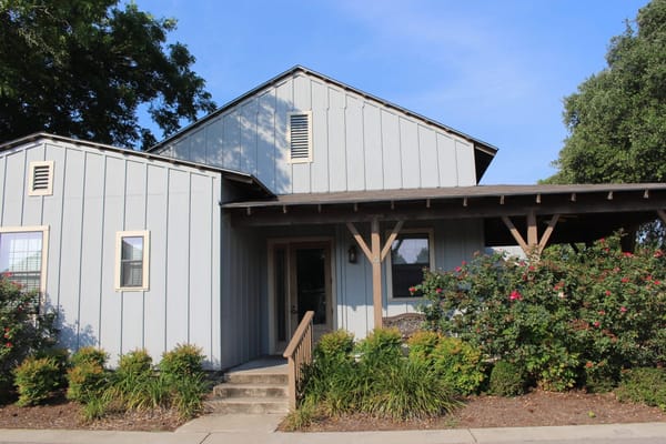 Exterior view of a senior living facility with garden