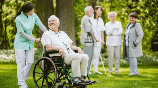 Residents and staff enjoying time outdoors in a garden