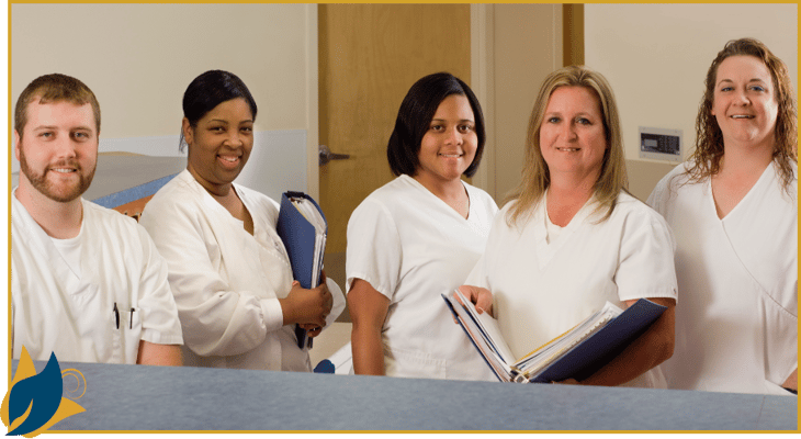 Staff members standing together in a clean, bright facility corridor