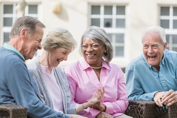 Group of happy residents enjoying conversation outdoors
