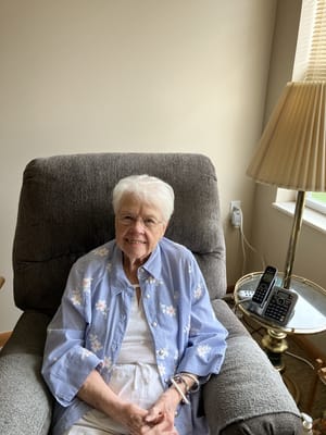 Resident smiling in a cozy chair