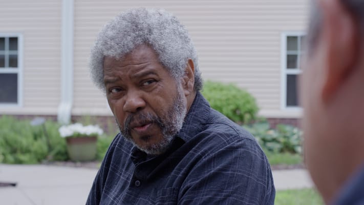 Two residents engaging in conversation outdoors