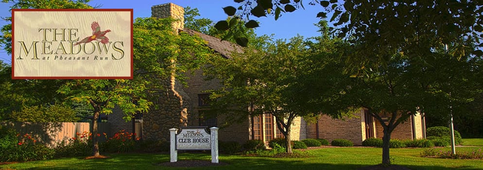 Exterior view of The Meadows facility with logo