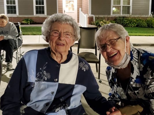 Two smiling residents enjoying time together