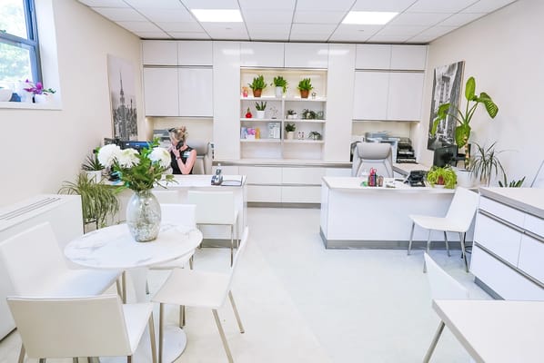 Bright, modern reception area with staff at work