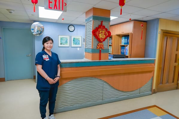 Staff member at a reception area in the facility