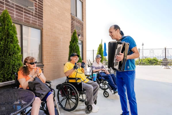 Musician entertaining residents on a patio