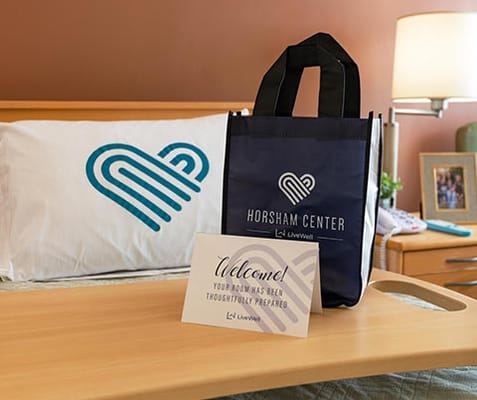 A welcoming setup in a resident's room with a bag and sign