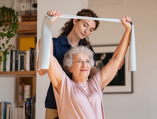 Staff assisting a resident with exercise therapy