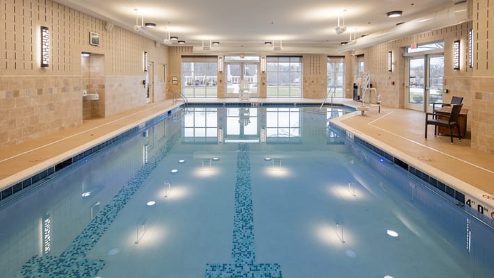Indoor swimming pool area with large windows
