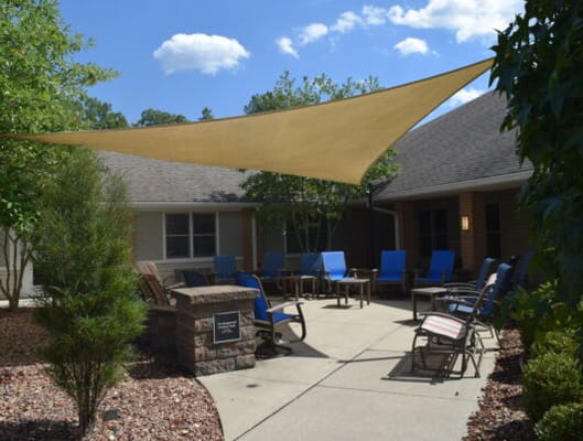 Outdoor patio area with lounge chairs and shade sails
