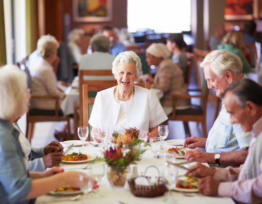 Residents enjoying a meal together in the dining room
