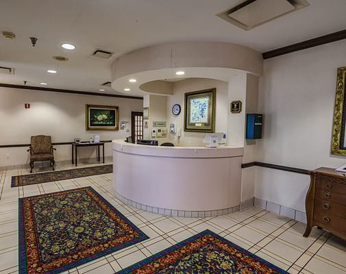 Reception area of a senior living facility with chairs and artwork