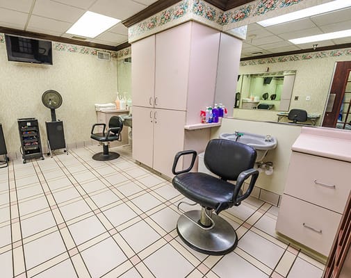 Senior salon area with styling chairs and equipment