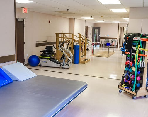 Interior view of a therapy room with fitness equipment