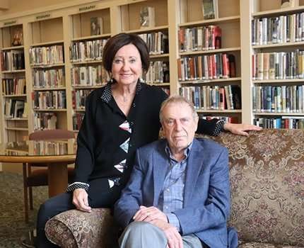 Two residents in a cozy library setting
