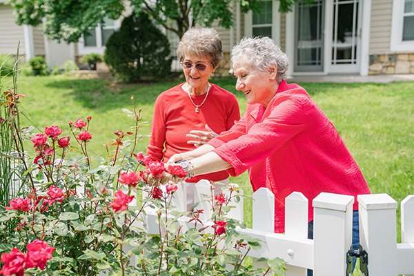 Two residents enjoying the garden flowers