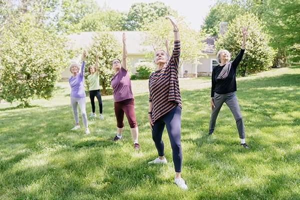 Residents engaged in a group exercise outdoors