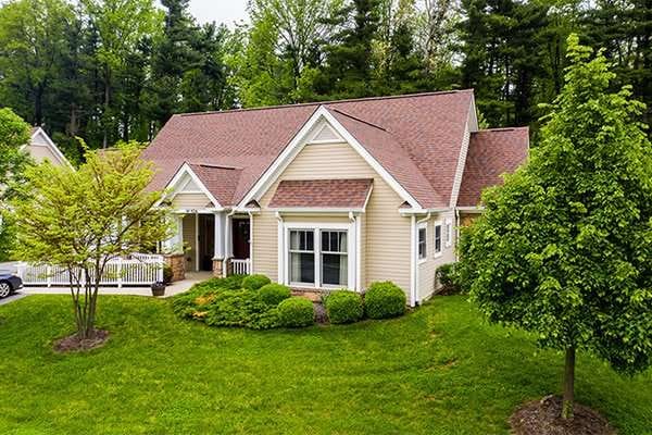 Exterior view of a residential-style facility surrounded by greenery