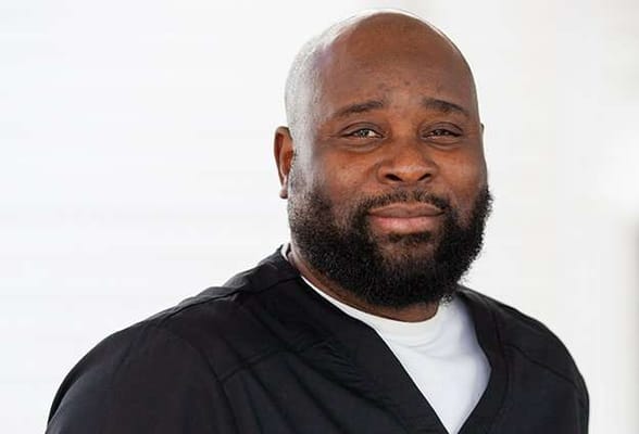 Close-up of a staff member with a friendly expression