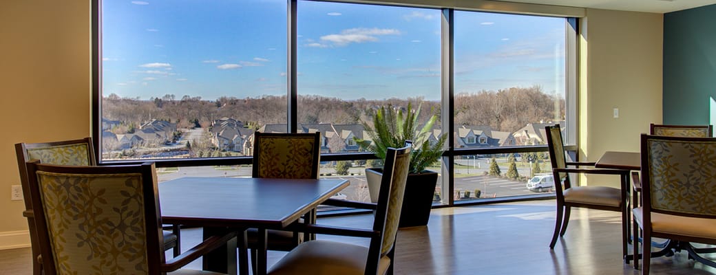 Common area with tables and a large window view