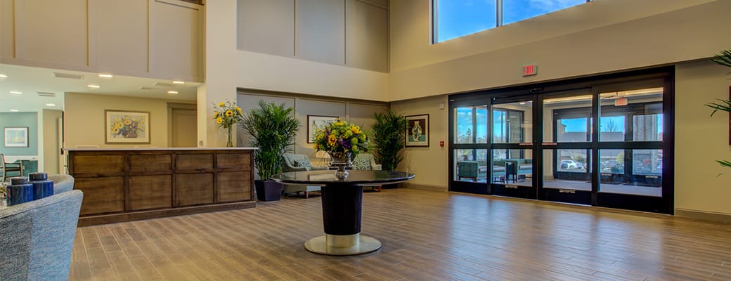 Bright lobby area with reception desk and flowers
