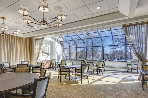 Bright common area with seating and large windows