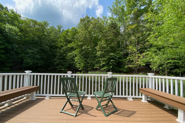Outdoor seating area by a serene pond
