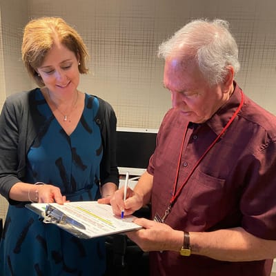 Staff helping a resident with paperwork in an indoor setting