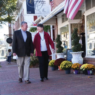 Couple walking outside with flower planters