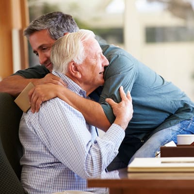 Two men embracing in a warm moment