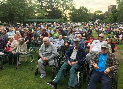 Residents enjoying an outdoor concert in a park