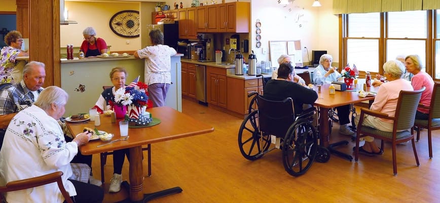 Residents enjoying meals in a common dining area
