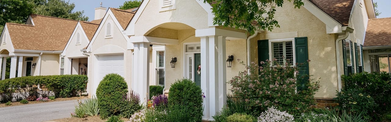 Exterior view of a senior living facility with landscaped gardens