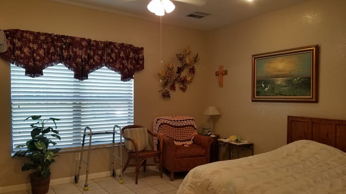 Cozy resident room with comfortable seating and window.